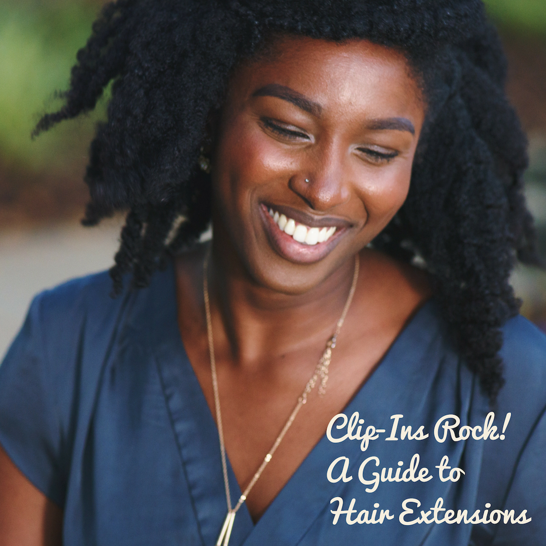 Clip-in extensions can enhance hairstyles such as this afro hairstyle worn by this happy woman